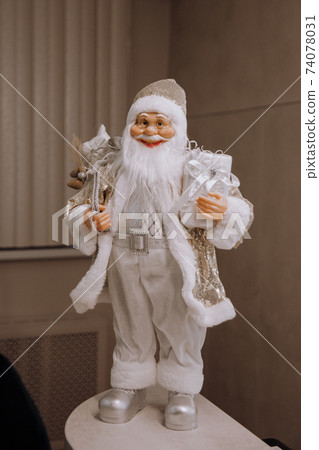 Toy rag Santa Claus with a bag of gifts on a dark background Toy rag Santa Claus with a bag of gifts on a dark background 74078031