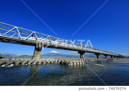 Shinkansen crossing the Fuji River and Mt. Fuji Shinkansen crossing the Fuji River and Mt. Fuji 74079374