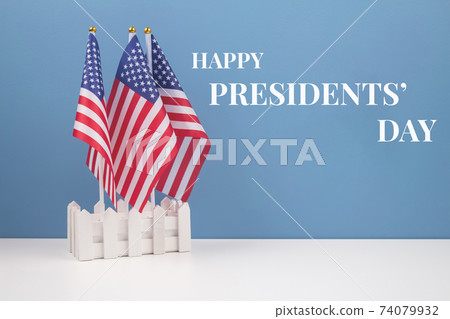 Creative composition with USA flags on white table with blue wall background - Presidents' Day 2021 concept Creative composition with USA flags on white table with blue wall background - Presidents' Day 2021 concept 74079932