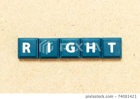 Tile alphabet letter in word right on wood background Tile alphabet letter in word right on wood background 74081421