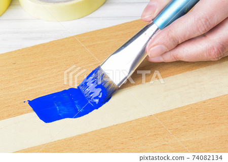 Using masking tape when painting with brush 74082134