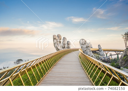 Famous tourist attraction - Golden bridge at the top of the Ba Na Hills, Vietnam 74082150