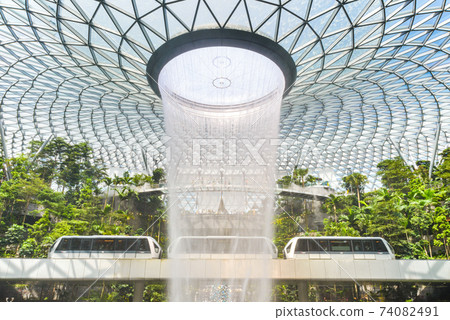 SINGAPORE - December 22, 2019: The largest indoor waterfall inside Jewel Changi Airport in Singapore SINGAPORE - December 22, 2019: The largest indoor waterfall inside Jewel Changi Airport in Singapore 74082491