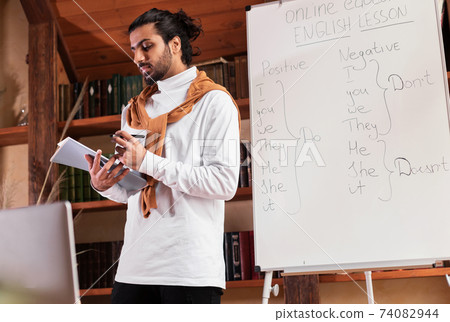 Indian Teacher Man Having Distant Online Class Indoors Indian Teacher Man Having Distant Online Class Indoors 74082944