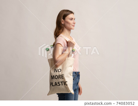 Eco Activist Woman Walking With Tote Bag With No More Plastic Inscription 74083052