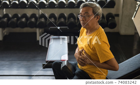 Old man heart attack during sit ups exercise in gym Old man heart attack during sit ups exercise in gym 74083242