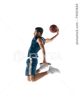 Young arabian basketball player of team in action, motion isolated on white background. Concept of sport, movement, energy and dynamic. 74083684