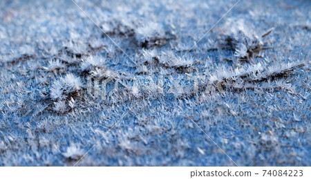 White hoarfrost crystals on flat surface macro view White hoarfrost crystals on flat surface macro view 74084223