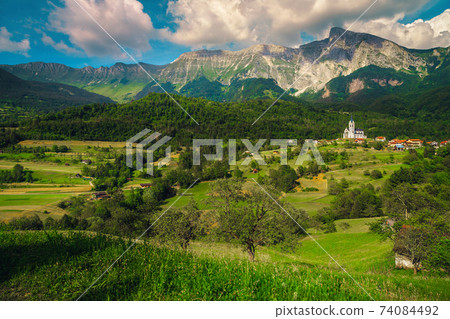 Breathtaking alpine landscape and Dreznica village with mountains, Slovenia Breathtaking alpine landscape and Dreznica village with mountains, Slovenia 74084492