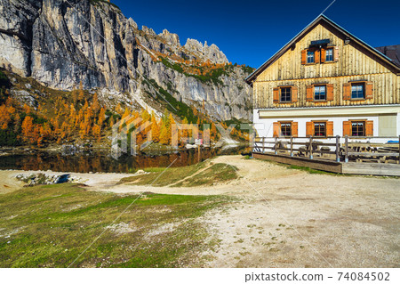 Cute house with terrace in the colorful autumn forest, Dolomites 74084502