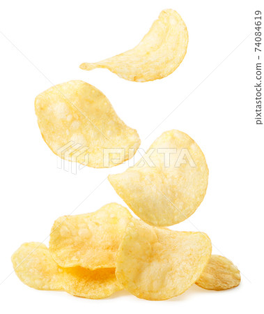 Potato chips are falling on a heap on a white 74084619