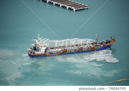 Suction Dredger Emptying Sluices, Spoiling Water of Gulf with mud Spot, Pollution, brown Muddy water - aerial shot 74084745