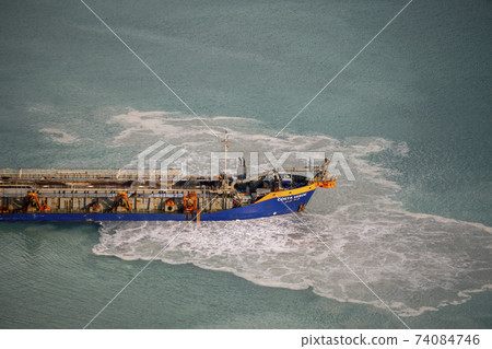 Suction Dredger Emptying Sluices, Spoiling Water of Gulf with mud Spot, Pollution, brown Muddy water - aerial shot 74084746