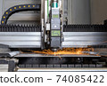 Programmable machine for laser cutting of metal. Sparks from laser cutting, 74085422