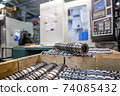 the steel part is large against the background of the cnc machine. Low-depth-of-field photography 74085432
