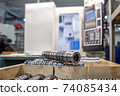 the steel part is large against the background of the cnc machine. Low-depth-of-field photography 74085434