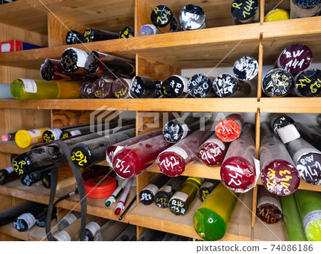 Colorful glass rods in rack. Source glasrods in a traditional  glass gallery 74086186