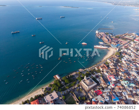 Very High Above Aerial Top View Shot of Stone Town, the Capital of Zanzibar, Tanzania. Sunset Time Coastal City in Africa 74086852
