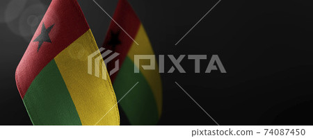 Small national flags of the Guinea Bissau on a dark background 74087450