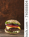 Deliciouse meat burger on rustic and wooden background. Place for text. 74088804