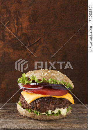 Deliciouse meat burger on rustic and wooden background. Place for text. Deliciouse meat burger on rustic and wooden background. Place for text. 74088804