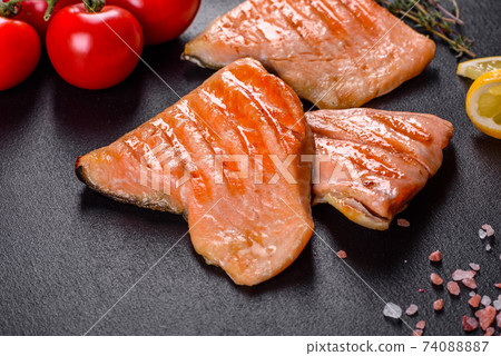 Tasty fresh red fish arctic char baked on a grill Tasty fresh red fish arctic char baked on a grill 74088887