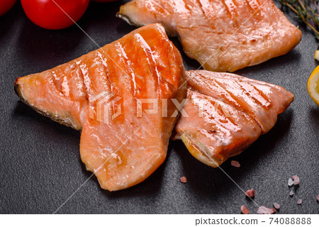 Tasty fresh red fish arctic char baked on a grill Tasty fresh red fish arctic char baked on a grill 74088888