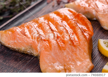 Tasty fresh red fish arctic char baked on a grill Tasty fresh red fish arctic char baked on a grill 74088917