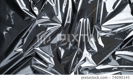 Plastic bag. Wrap transparent dark cellophane texture. Black shiny film pattern. Creative crumpled background. Plastic bag. Wrap transparent dark cellophane texture. Black shiny film pattern. Creative crumpled background. 74090145
