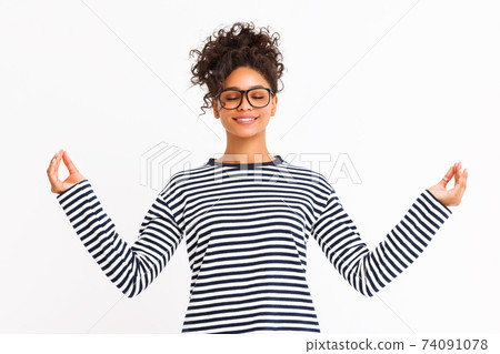 Young woman meditating with closed eyes Young woman meditating with closed eyes 74091078