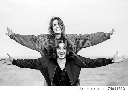 Happy young couple having fun outdoors together 74091810
