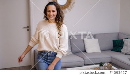 Young pretty woman in her living room 74093427