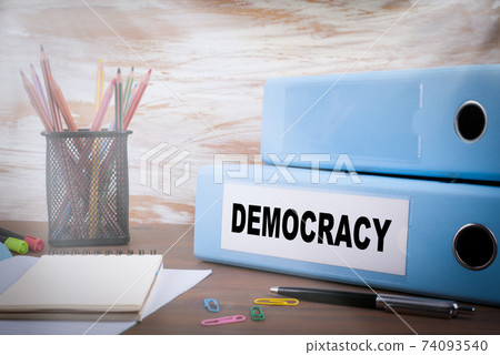 Democracy concept. On the table Office Binder, colored pencils, pen andnotebook paper Democracy concept. On the table Office Binder, colored pencils, pen andnotebook paper 74093540