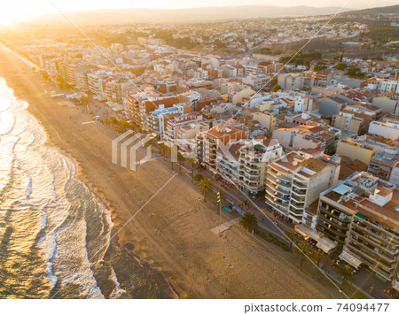 Aerial view of coast at Calafell cityscape with a modern apartment buildings Aerial view of coast at Calafell cityscape with a modern apartment buildings 74094477