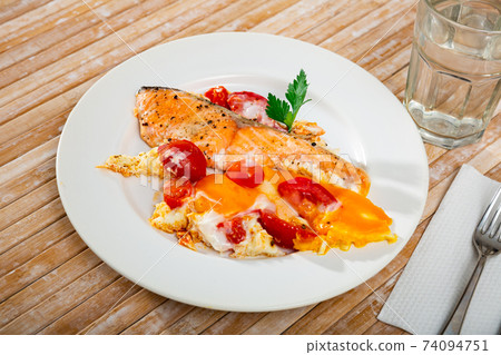 Fried eggs with salmon and cherry tomato Fried eggs with salmon and cherry tomato 74094751