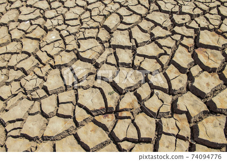 The drought land texture in Thailand. The global shortage of water on the planet. Global warming and greenhouse effect concept. The drought land texture in Thailand. The global shortage of water on the planet. Global warming and greenhouse effect concept. 74094776