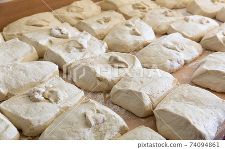 Prepared raw dough on tray in bakery Prepared raw dough on tray in bakery 74094861