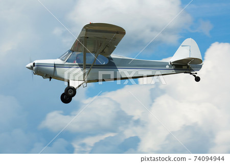 Sport airplane soaring in sky Sport airplane soaring in sky 74094944