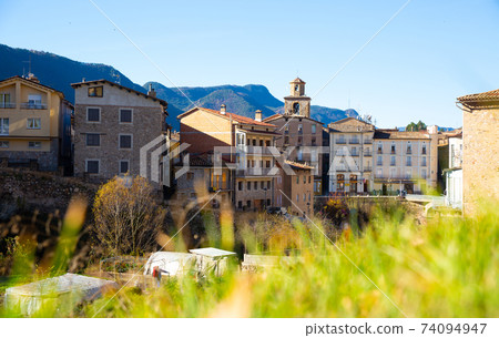 street with river and residential buildings in La Pobla de Lillet in Spain street with river and residential buildings in La Pobla de Lillet in Spain 74094947