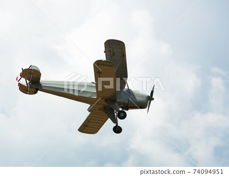 Biplane flying in sky Biplane flying in sky 74094951