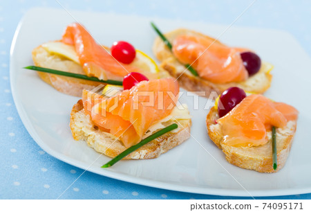 Tapas with salmon, lemon, cranberry 74095171