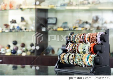 Bracelets from precious stones in jewelry store 74095359