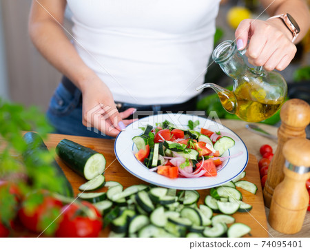 Cooking vegetable salad of cucumbers and tomatoes 74095401