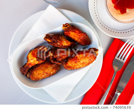 fried hot chicken wings on white plate for brunch fried hot chicken wings on white plate for brunch 74095639