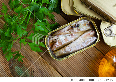 Tasty canned mackerel fish in sunflower oil with greens Tasty canned mackerel fish in sunflower oil with greens 74095649