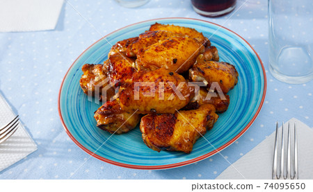 Tasty spicy deep fried unbreaded chicken wings Tasty spicy deep fried unbreaded chicken wings 74095650