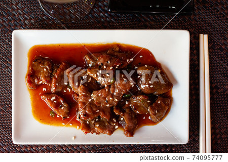 Wok with veal and sesame seeds. Japanese cuisine 74095777