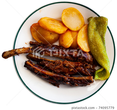 Barbecued pork ribs with baked potatoes and green pepper Barbecued pork ribs with baked potatoes and green pepper 74095779