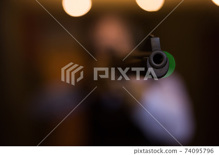Front sight and barrel of an automatic combat rifle closeup 74095796