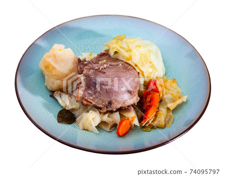 Pork cheeks with stewed cabbage leaves Pork cheeks with stewed cabbage leaves 74095797